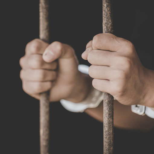 Man holding prison bars